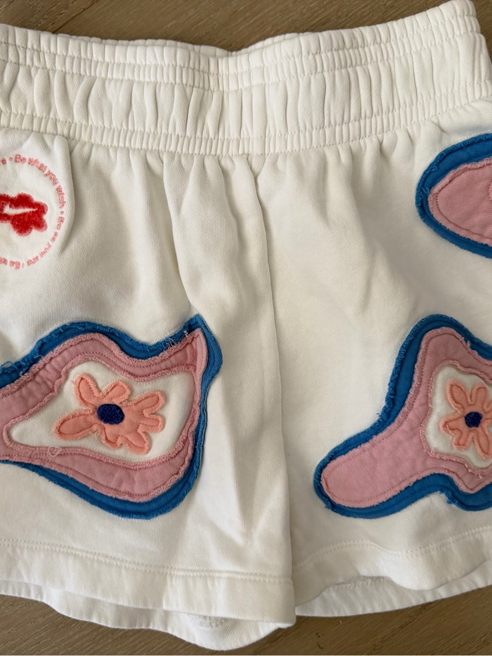 Nike White Athletic Shorts with Pink and Blue Floral Appliqués - Picture 7 of 8